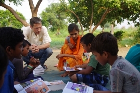 Children study English using the <i>Ollie the Elephant</i> books, at one of the slums in India where Charity United's educational programs are in operation.