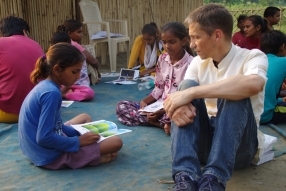 Children study English using the <i>Ollie the Elephant</i> books, at one of the slums in India where Charity United's educational programs are in operation.