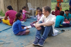 Children study English using the <i>Ollie the Elephant</i> books, at one of the slums in India where Charity United's educational programs are in operation.