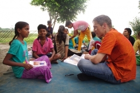 Children study English using the <i>Ollie the Elephant</i> books, at one of the slums in India where Charity United's educational programs are in operation.