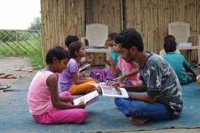 Children study English using the <i>Ollie the Elephant</i> books, at one of the slums in India where Charity United's educational programs are in operation.