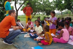 Children study English using the <i>Ollie the Elephant</i> books, at one of the slums in India where Charity United's educational programs are in operation.
